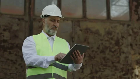 Architect working on digital tablet at building site Stock Footage 203875182