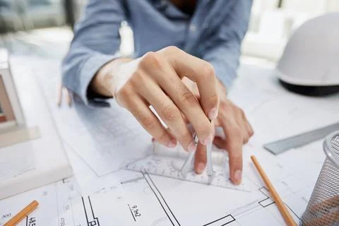 Architect working on drawing table in office Stock Photos