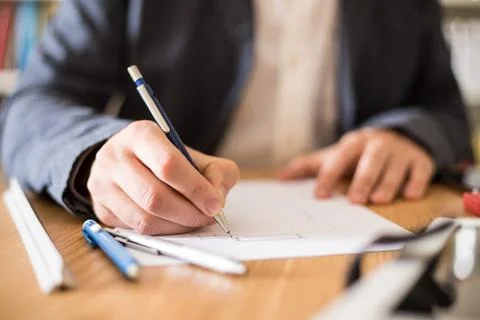 Architect working at his desk drawing a sketch. Foto stock