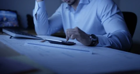 Architect working at his desk late at night Stock Footage 107643494