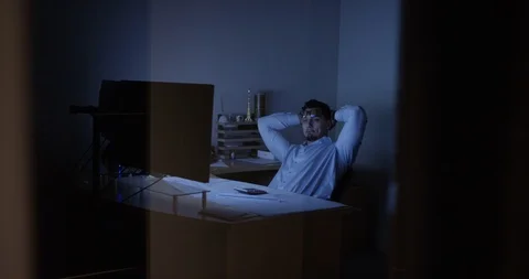 Architect working at his desk late at night Stock Footage 107643625