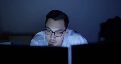 Architect working at his desk late at night Stock Footage 107643802