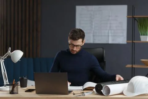 Architect working in office with blueprints.Engineer inspect architectural plan Stock-Fotos