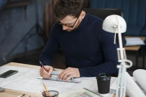 Architect working in office with blueprints.Engineer inspect architectural plan Stock Photos