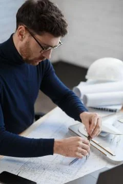 Architect working in office with blueprints.Engineer inspect architectural plan Stock Photos