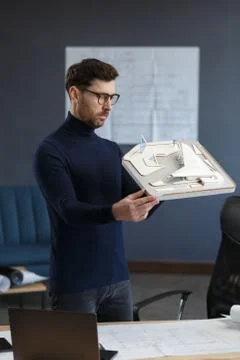 Architect working in office with building 3D model. Engineer inspect building Stock Photos