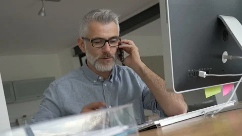 Architect working in office on desktop, talking on phone Video stock 124066322