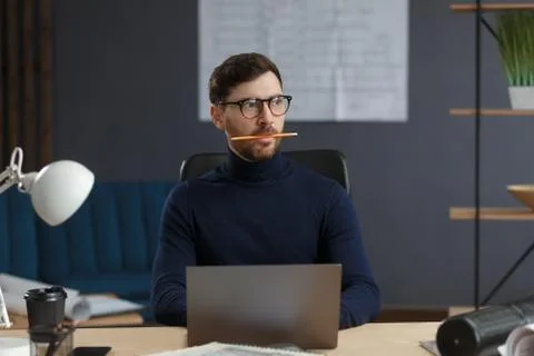 Architect working in office with laptop.Engineer thinks over architectural plan Stock Photos