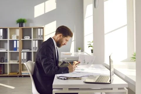 Architect working in office, using city maps and developing new construction Stock Photos