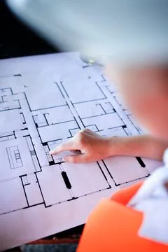 Architect working over plan. Closeup Desk With blueprints drawing. Stock Photos