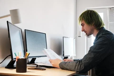 Architect Working On Project In Office. Architect working with blueprints. Stock Photos