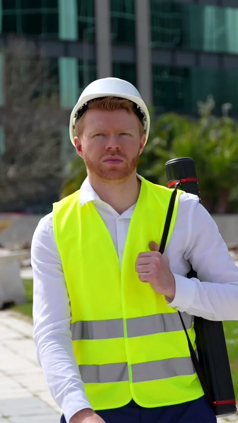 Architect working with safe clothes holding a draw tube outdoors Stock Footage 274465590