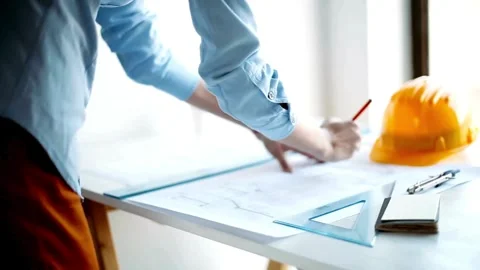 Architect working using Ruler and Pencil to make blueprint while standing on a 库存影片 336565952