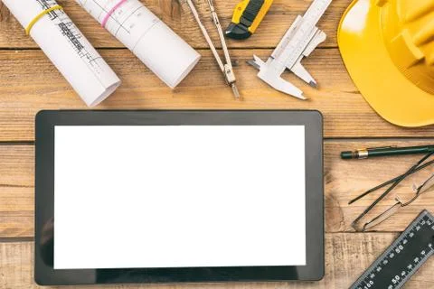 Architect workplace and technology. Tablet with white blank screen, project c Stock Photos
