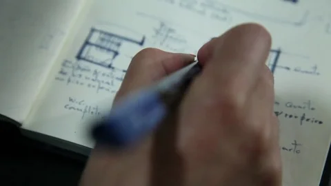 Architect writing ideas in notebook house architecture plan Stock Footage 72444759