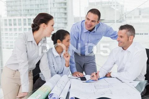Architects anaylzing plans together Stock Photos