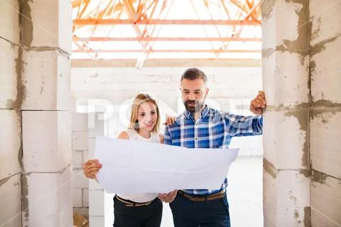 Architects and civil engineer at the construction site. Stock Photos