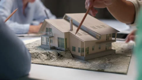 Architects and designers working on design of house layout in creative office Stock Footage 164983202