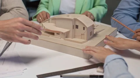 Architects and designers working on design of house layout in creative office Stock Footage 164983867