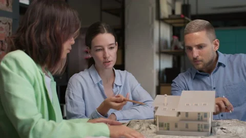 Architects and designers working on design of house layout in creative office Stock Footage 164985810