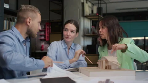 Architects and designers working on design of house layout in creative office Stock Footage 164986346