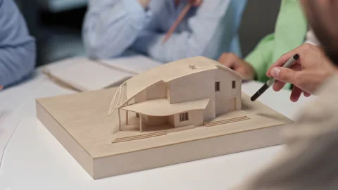 Architects and designers working on design of house layout in creative office Stock Footage 164989633