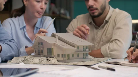 Architects and designers working on design of house layout in creative office Stock Footage 164991221