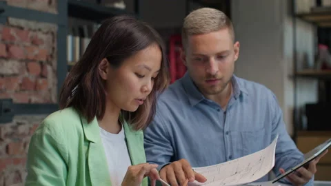 Architects and designers working on design of house blueprint in creative office Stock Footage 164991245