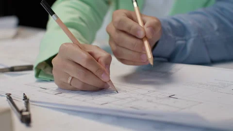 Architects and designers working on design of home blueprint in creative office Stock Footage 164991764
