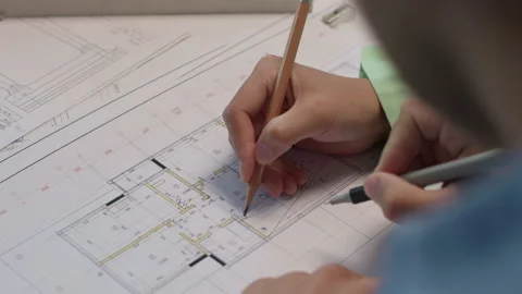 Architects and designers working on design of home blueprint in creative office Stock Footage 164993859