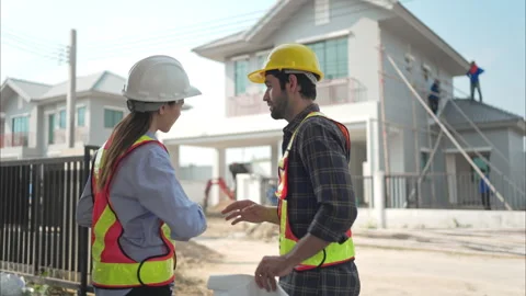 Architects and engineers work together to assess the residential home Video stock 308929370