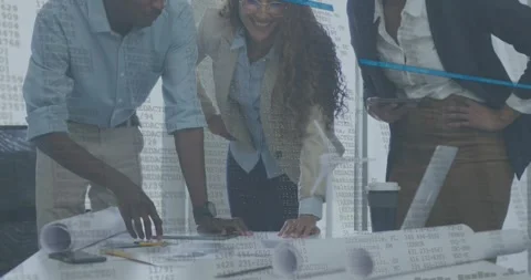 Architects approaching table studying blueprint tapping phone with data overlay Stock Footage 318064063