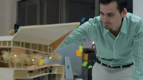 Architects are not satisfied with the model design at modern office. Stock-Footage 106864665