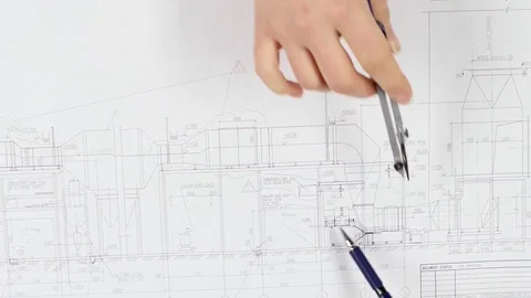Architects are sitting at the table analyzing the drawing. Close up Stock Footage 73677937