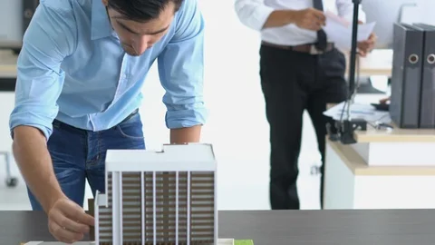 Architects are working on a building model at modern office. Stock-Footage 106669275