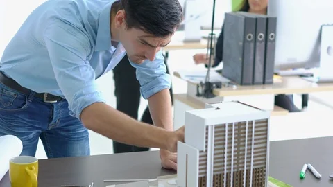 Architects are working on a building model at modern office. Stock-Footage 106669504