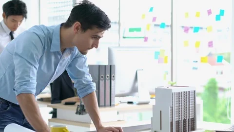 Architects are working on a building model at modern office. Stock-Footage 106669837