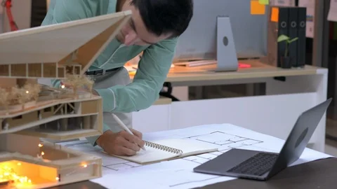 Architects are working on a building model at modern office. Stock Footage 106863520