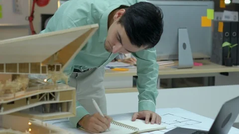 Architects are working on a building model at modern office. Stock Footage 106863828