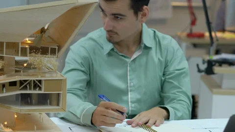 Architects are working on a building model at modern office. Stock Footage 106863958