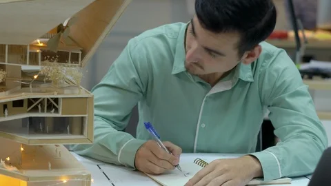 Architects are working on a building model at modern office. Stock Footage 106864189