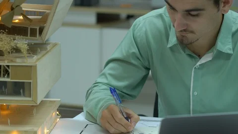 Architects are working on a building model at modern office. Stock Footage 109378386