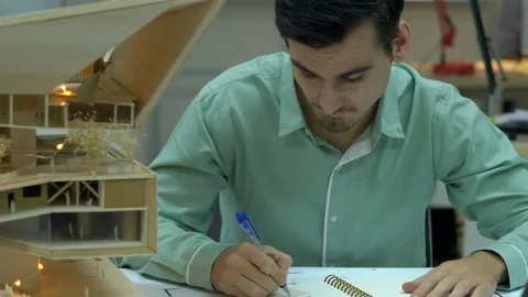Architects are working on a building model at modern office. Stock Footage 109379137