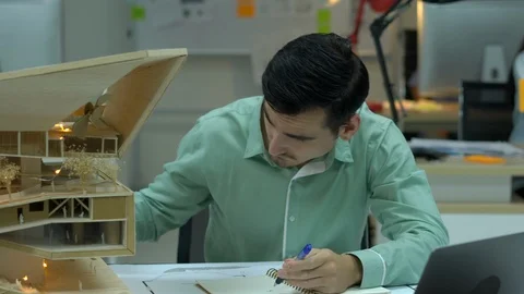 Architects are working on a building model at modern office. Stock Footage 109379349