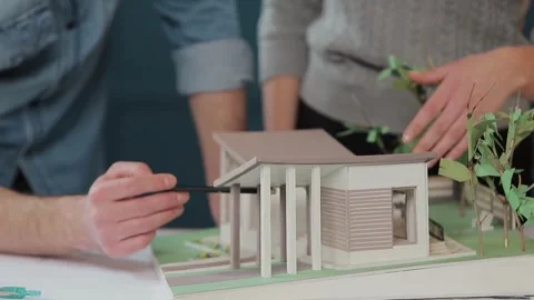 Architects are working on a building model. Designer are developing architecture Stock Footage 336573741
