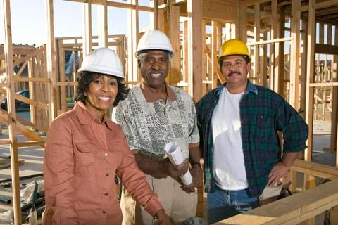 Architects With Blueprint At Construction Site Stock Photos