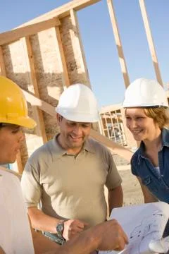 Architects With Blueprint Discussing Stock Photos