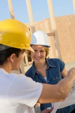 Architects With Blueprint Discussing Stock Photos
