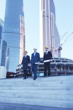 Architects with blueprint Stock Photos