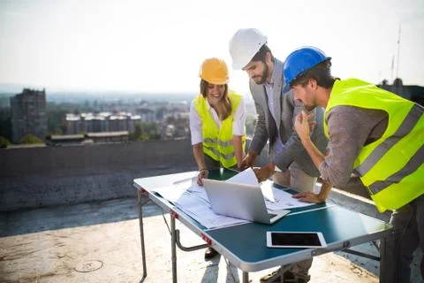 Architects, business manager and engineer meeting project at building site Stock Photos